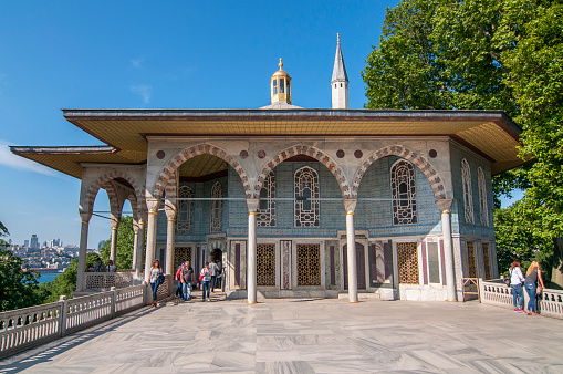 Tourists visiting terrace with Baghdad Kiosk and Iftar Pavilion in the Fourth courtyard of Topkapi Palace, Istanbul, Turkey.