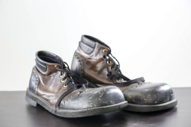 Pair of old working boots on black