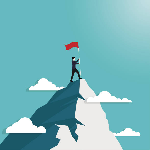 istock Businessman standing hold flag conquering top of mountain 1198668917