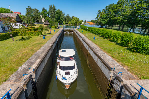 Boat entering gateway sluice (locks) on the Augustow Canal, Poland.
