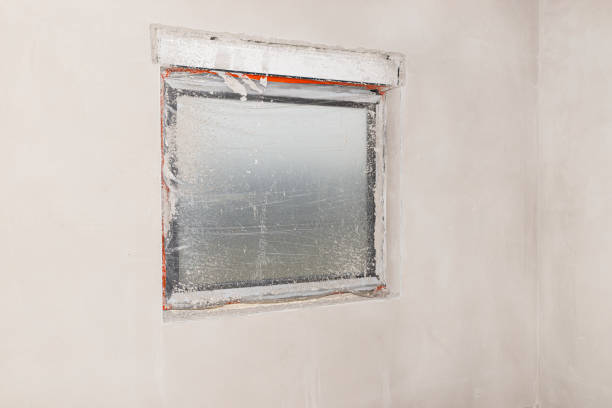 istock Windows in the house being built, protected with foil during the application of cement-lime plaster. 1198672428