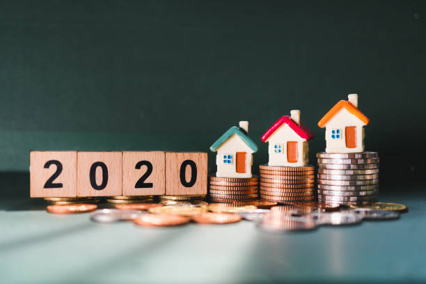 istock Wooden block year 2020 and mini house 1198677279