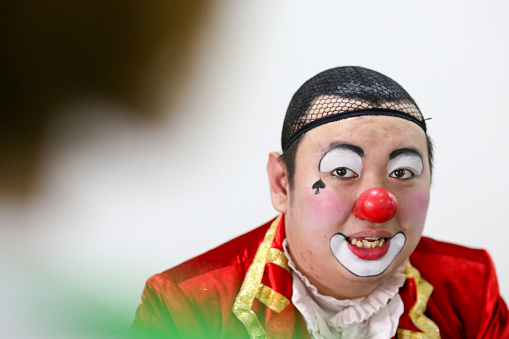 Portrait of clown performer gearing ready for performance.