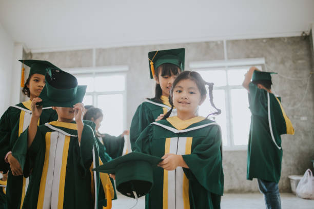 istock Group of Thai elementary age students at graduation ceremony stock photo 1198680186