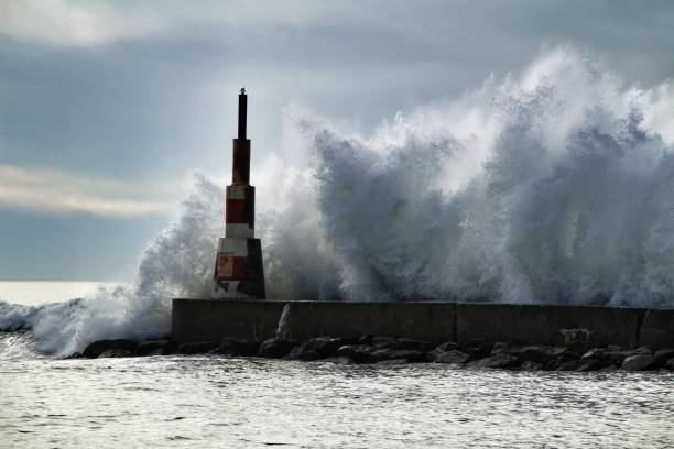 istock Giant waves breaking on the breakwater and the lighthouse 1198681704