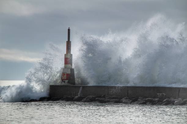 istock Giant waves breaking on the breakwater and the lighthouse 1198681777