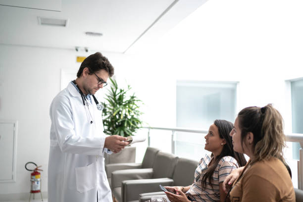 istock Doctor talking to patients at hospital 1198682416