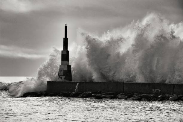 istock Giant waves breaking on the breakwater and the lighthouse 1198682577
