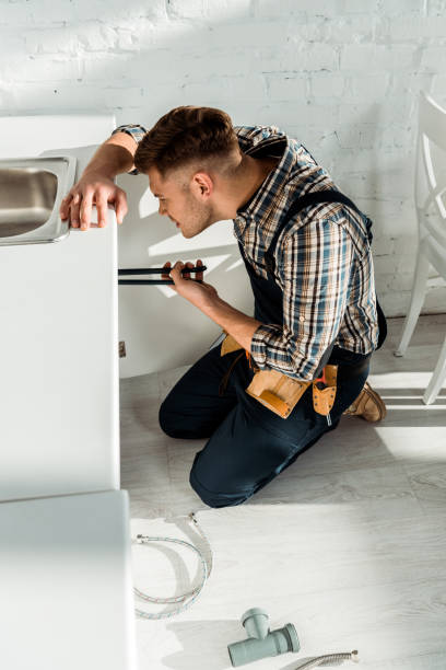 istock side view of installer holding slip joint pliers while working near kitchen cabinet 1198682808