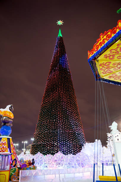 istock Winter carousel park forest snow. Christmas tree in the town square 1198684783