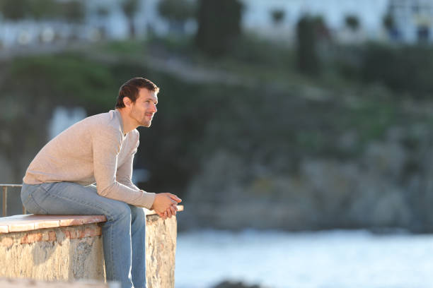 istock Serious pensive man contemplating views on the beach 1198686093