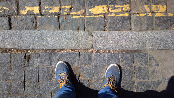 istock Feet on a stone road. 1198689078