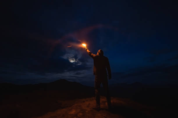 istock The man with a firework stick standing on the night mountain 1198689204