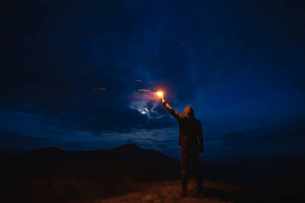 istock The male with a firework stick standing on a mountain. evening night time 1198689223