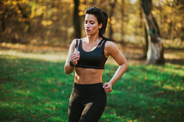 istock Female running in the forest 1198691632