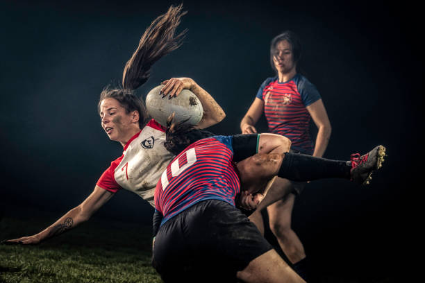 Female rugby player getting tackled stock photo