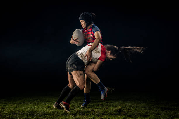 istock Female rugby player getting tackled 1198693508