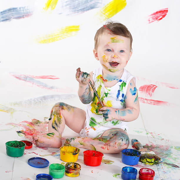 istock little girl bedaubed with bright colors 119869368