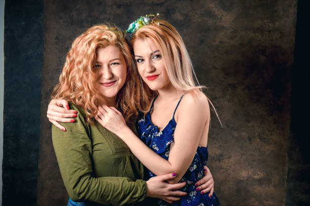 istock Two girls posing together 1198694618