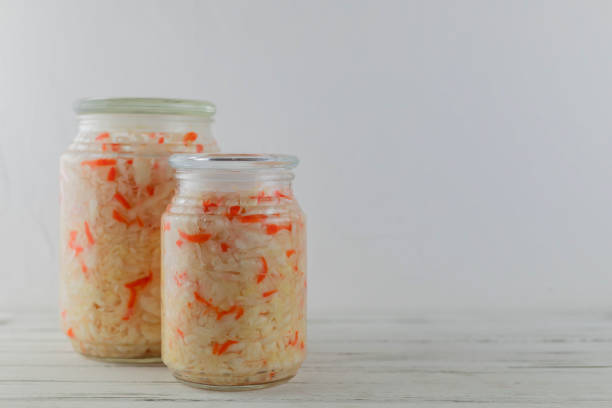 istock glass jars of fermented white cabbage, cucumbers, tomato, onions. vegetables on a light background. fermentation is a source of probiotic 1198700874