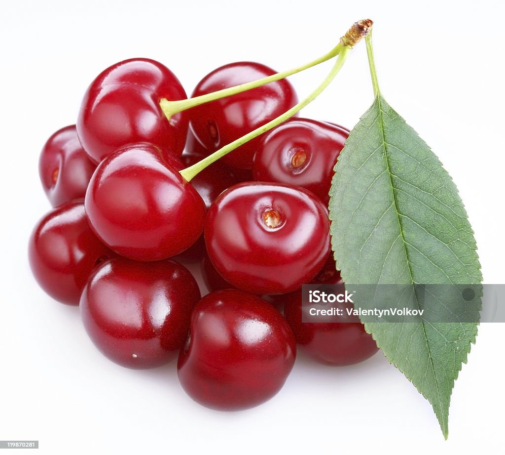 Photo of  ripe cherries with a leaf.  Berry Stock Photo
