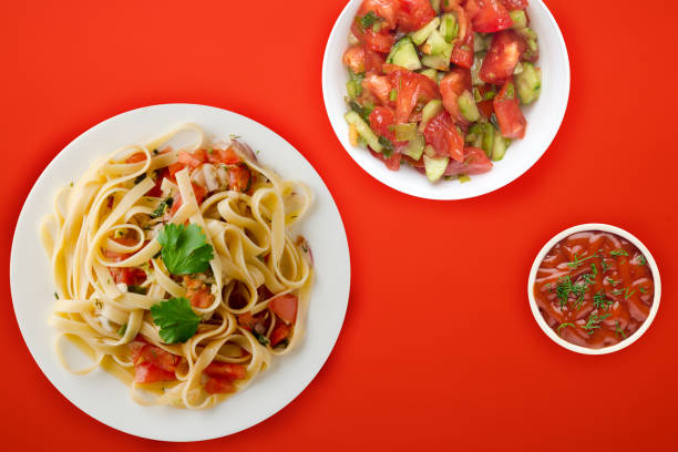 istock spaghetti on a white plate. spaghetti tomatoes, onions, cabbage on a colored background. healthy food 1198705114