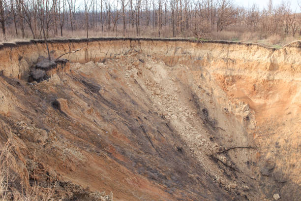 istock Failing funnel in a forest belt after underground mining 1198708287