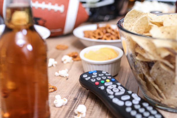 istock Watching the football game with snacks, drinks. 1198709477