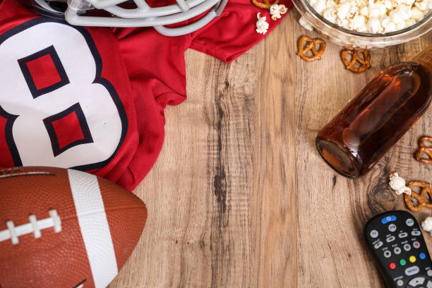 istock Watching the football game with snacks, drinks. 1198709546