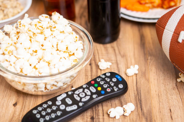 istock Watching the football game with snacks, drinks. 1198709689