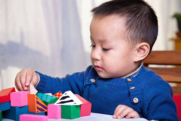 istock boy playing with wooden blocks 119871051