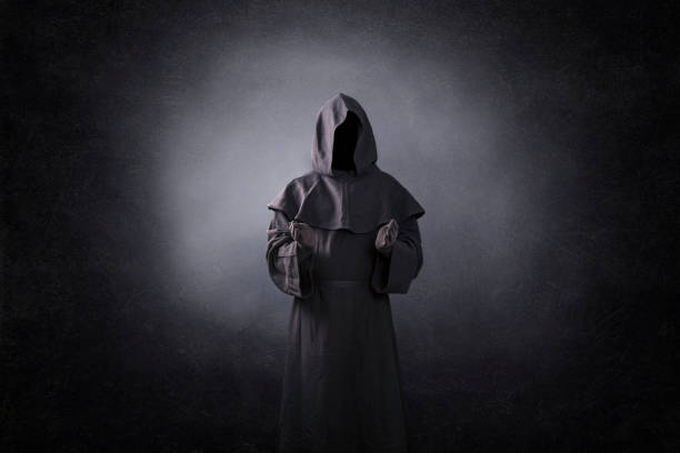 Ghostly figure with open hands in the dark Ghostly figure with open hands in the dark ceremonial robe stock pictures, royalty-free photos & images