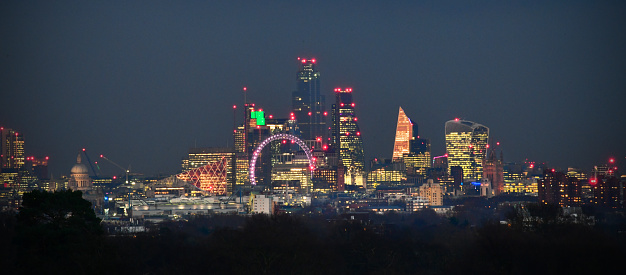 The first full moon of the decade rises over central London. Photographed from eleven miles away (Richmond Park) in order to compress together all the buildings of central London