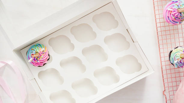 istock Boxing unicorn chocolate cupcakes into a white cupcake box. 1198714640