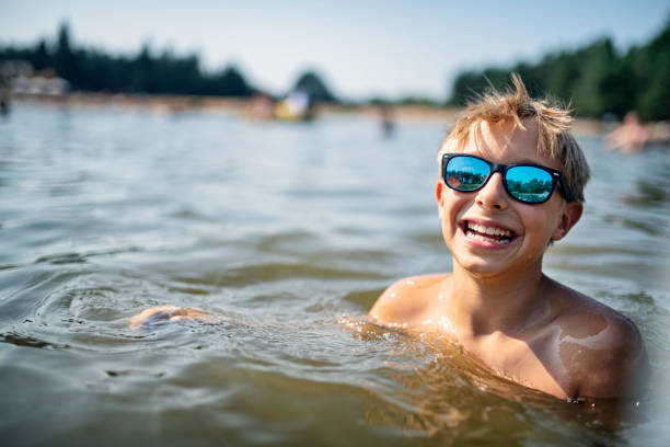 istock Kids enjoying playing in lake 1198718919