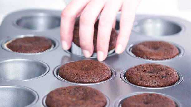 istock Cooling freshly baked chocolate cupcakes on a cooling rack. 1198719945
