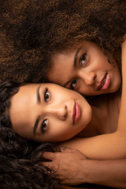 Beautiful African American and Asian women Beautiful African American and Asian women on a gray background. diverse models stock pictures, royalty-free photos & images