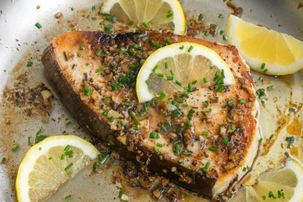 pesce spada all'aglio al limone scottato in padella in una padella - green steak food gourmet foto e immagini stock
