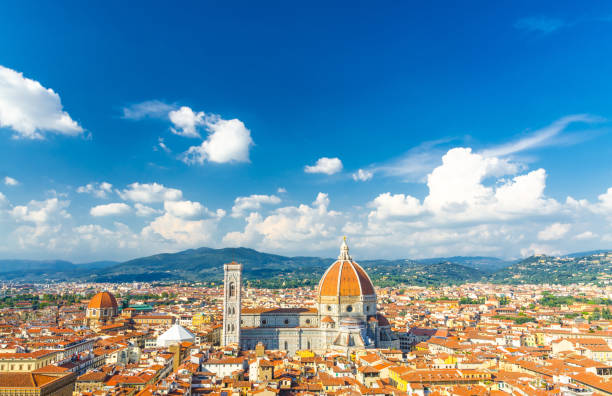top aerial panoramic view of florence city with duomo cattedrale di santa maria del fiore cathedral, buildings houses with orange red tiled roofs and blue sky white clouds, copy space, tuscany, italy - roof tile architectural detail architecture and buildings built structure imagens e fotografias de stock