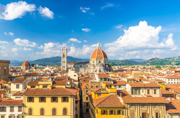 top aerial panoramic view of florence city with duomo cattedrale di santa maria del fiore cathedral, buildings houses with orange red tiled roofs and hills range, blue sky white clouds, tuscany, italy - roof tile architectural detail architecture and buildings built structure imagens e fotografias de stock