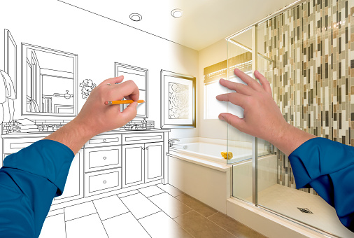 Male Hands Sketching Beautiful Custom Bathroom Gradating to Finished Construction.