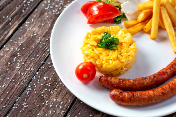istock Scrambled eggs and sausage with some fried and fresh vegetables, Scrambled eggs and sausage with some fried and fresh vegetables 1198734710