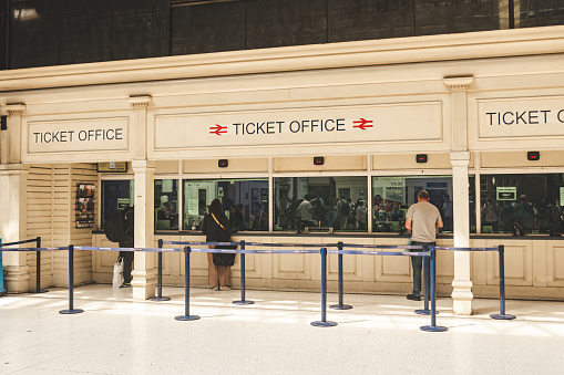 London/UK - 22/07/2019: people buying train tickets at the Marylebone Station's ticket offices. The station is linking London to the cities of Nottingham, Sheffield and Manchester; selective focus