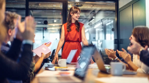 Female manager getting an applause after a succesful meeting