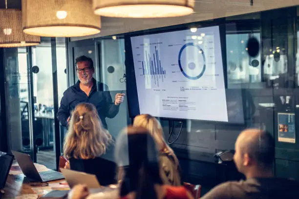 Photo of Caucasian businessman giving presentation in a conference room