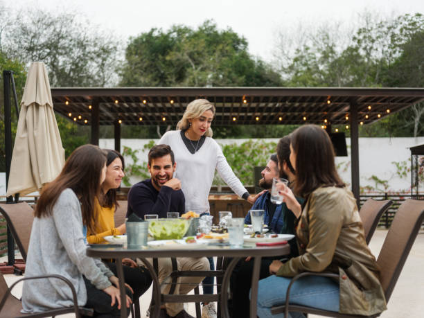 istock Large group of joyful friends having fun while eating 1198738288