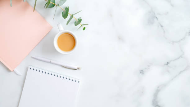 istock Wedding planner, cup of coffee, pink notebook, pen, eucalyptus leaf on marble desk. Flat lay, top view, copy space. Wedding, bridal, marriage concept. 1198740759