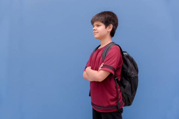 istock boy ready to back to the school, back to school background blue 1198742200