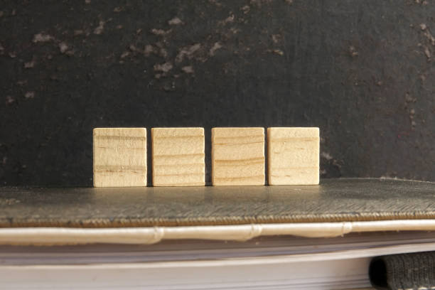 istock Blank wood scrabble pieces isolated on grunge black background. 1198745780