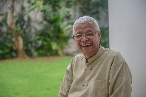 Asian old man with white hair smiling